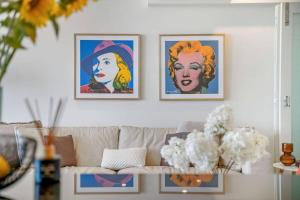 a living room with three pictures on the wall at Lookout 334 - Endless Ocean Views - Rooftop Spa in Kingscliff