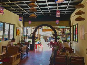 a restaurant with people sitting at tables in a room at Thoc House Ta Van in Lao Tchay