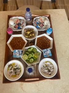 amzran hotel siwa في سيوة: صينية طعام على طاولة مع أطباق من الطعام