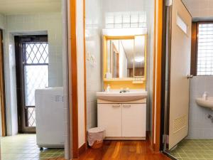 a bathroom with a sink and a refrigerator in it at AGARI 伊江島 Ie Island in Ie