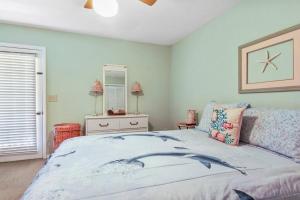 a bedroom with a bed and a dresser and a mirror at Kimberly Villa in Panama City Beach