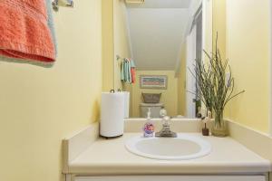 a bathroom with a sink and a mirror at Kimberly Villa in Panama City Beach +14 photos