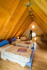 a room with three beds in a attic at Case Vacanza Orchidea in Coreglia Antelminelli