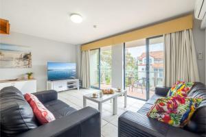 a living room with a couch and a table at Nelson Bay Breeze Apartment, 29,1 Trafalgar Street - Air conditioned unit with Linen supplied, complex pool and spa in Nelson Bay