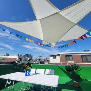 a white table and chairs under a tent on a roof at Reve Guwol in Incheon