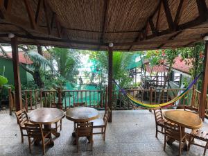 a patio with tables and chairs and a playground at El Marabu Chill'n Surf in Aposentillo