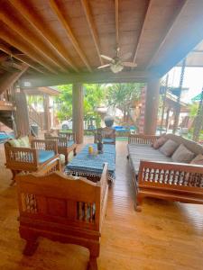 a living room with wooden furniture and a couch at 泰小院儿（99 Friend’s house Lanna ) in Chiang Mai