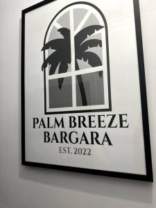 a framed picture of a barcelona sign on a wall at Palm Breeze - 4 bedroom -Walk to the beach in Bargara