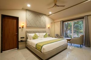 a bedroom with a large bed and a window at Bageecha Resort in Pushkar