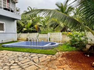 a swimming pool in the yard of a house at Sea Nest in Alibaug