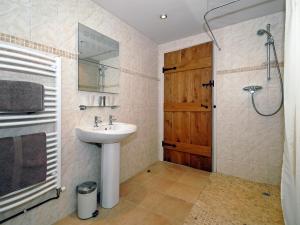 a bathroom with a sink and a shower at Rias Cottage in Landshipping