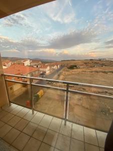 a balcony with a view of a road and buildings at El Rincón del Marqués in Las Navas del Marqués