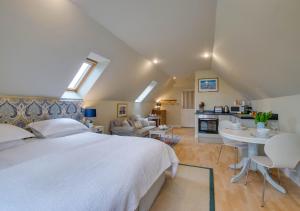 a bedroom with a large bed and a living room at The Barn Studio in Benenden