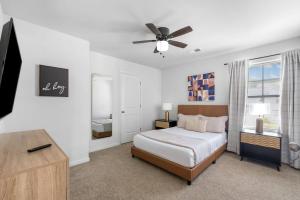 a bedroom with a bed and a ceiling fan at Quiet Oasis in Lawrenceville
