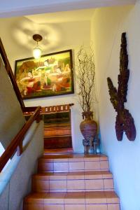 a staircase with a vase and a painting on the wall at Fulay Hotel in Hua Hin