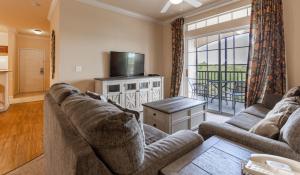 a living room with a couch and a tv at 8000TW Unit 4403- Tuscana Resort in Kissimmee