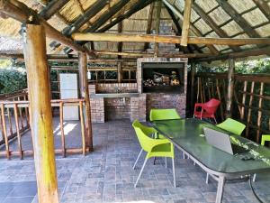 eine Terrasse mit einem Tisch, Stühlen und einem Kamin in der Unterkunft Nonesi Lodge 2 in Queenstown