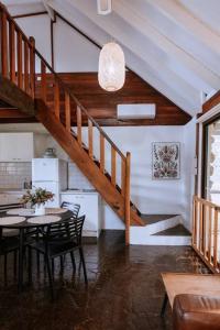 a kitchen and dining room with a table and a staircase at Cottage 3 - The Row in Forest Grove