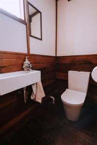 a bathroom with a toilet and a sink and a mirror at Cottage 3 - The Row in Forest Grove