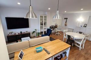 a living room with a couch and a table at Occidente Costa Verde Asturiana 