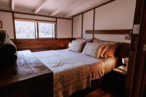 a bedroom with a bed and a window at Cottage 3 - The Row in Forest Grove