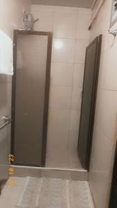 a shower stall with a door in a bathroom at Roca Mar ROCAWELCH Puerto Viejo in Puerto Viejo