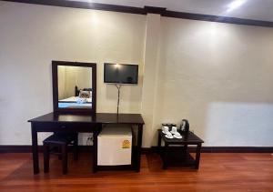 a room with a mirror and a desk with a mirror at Y Not Lao Villa in Luang Prabang
