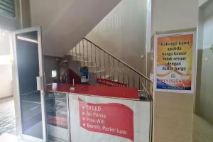a stair case with a red counter and a staircase at Capital O 93250 Hotel Tirta Kencana 2 Baturaden in Banyumas