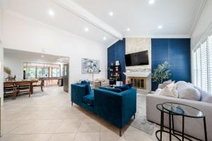 a living room with a blue accent wall at Elegant Retreat w/ Game room in Heart of OC in Midway City