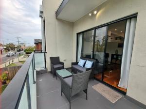 a balcony with a table and chairs on a building at Rosie Townhouse in prime location close to CBD in Melbourne