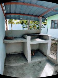 a concrete bench with a roof on top of it at Dream Villa Homestay Kuala Nerang in Kuala Nerang