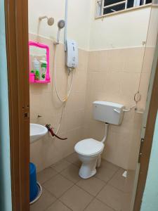 a small bathroom with a toilet and a sink at Wafiy Homestay in Machang