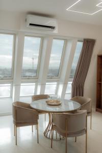 a dining room with a table and chairs and windows at NED Hotel in Graz