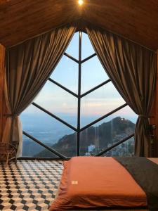 a bedroom with a large window with a view at Lego Homestay Tam Đảo Venuestay in Vĩnh Phúc