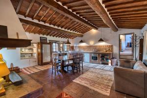 a large living room with a table and a couch at Casale Al Sole Tra Le Vecchie Vigne 6 and 10 - Happy Rentals in Radda in Chianti