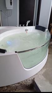a bath tub filled with water in a bathroom at Bmf Homestay Jacuzzi in Tacloban