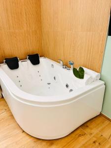 a white bath tub sitting in a room at Mensos in Olbia
