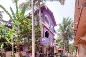 a purple building with a sign in front of it at Ps Guest House Near Calangute Beach in Calangute