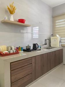 a kitchen with a sink and a counter top at LYL HOMESTAY-IPOH 10Pax 4R in Ipoh