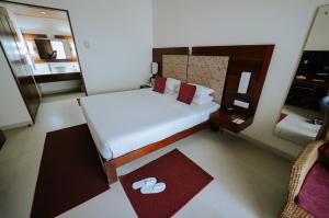 Letto o letti in una camera di Hotel Devaragam by K P Namboodiri's