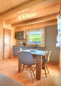 a kitchen with a table and chairs in a cabin at JAFERÓWKA Domki w górach in Żywiec