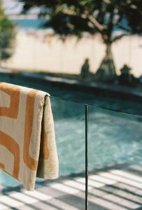 a towel on a railing next to a swimming pool at 71 Hastings Street in Noosa Heads