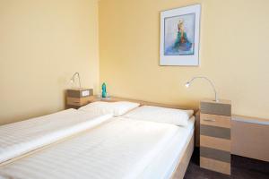 Postel nebo postele na pokoji v ubytování Roomingtons Lüneburger Heide