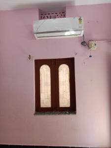 a window in a room with a air conditioner above it at 1 BHK House with AC fully operational kitchen with wifi in Hyderabad