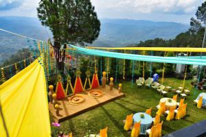 a party in the garden with a tent and chairs at Peaks And Pines Resort in Lansdowne