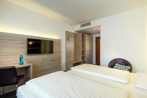 Postel nebo postele na pokoji v ubytování Roomingtons Lüneburger Heide