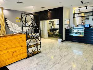 a store lobby with a counter and a store at Golden Crown Hotel Alseeb Muscat in Seeb