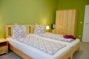 Kerkwitz的住宿－Ferienwohnung "Zum Dorfkrug"，一间卧室设有一张带绿色墙壁的大床