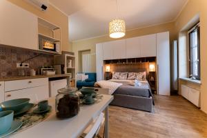 cocina y sala de estar con cama y mesa en Le fantasie di Tizi, en Alpignano