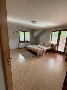 una camera con un letto in una stanza con finestre di Chata Nižná Boca a Nižná Boca